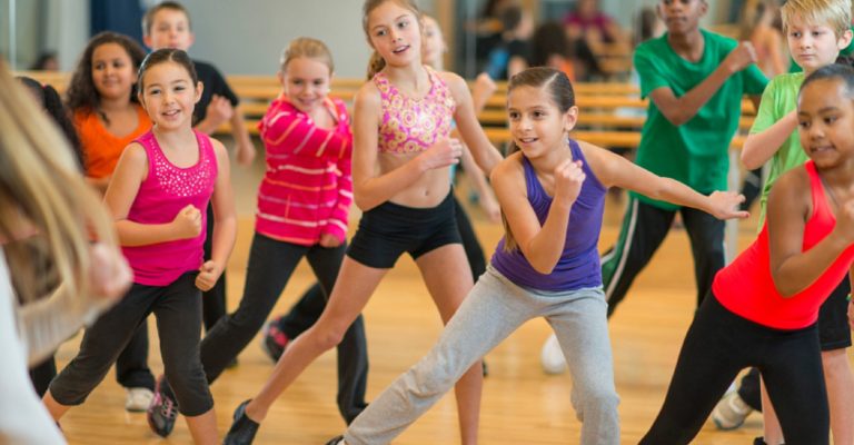 Diverse group of children taking a zumba dance fitness class
